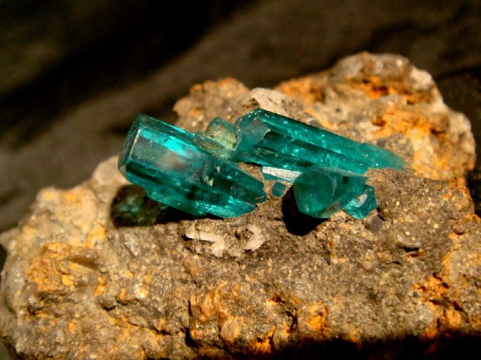 Turquoise crystals on rough stone, showcasing beautiful minerals and stones.