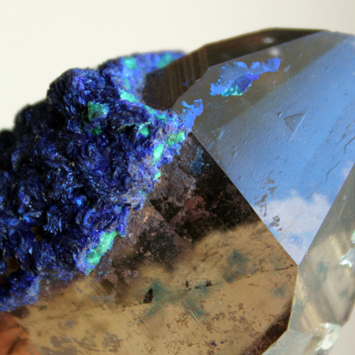 Close-up of a beautiful mineral featuring vibrant blue and green crystal formations.