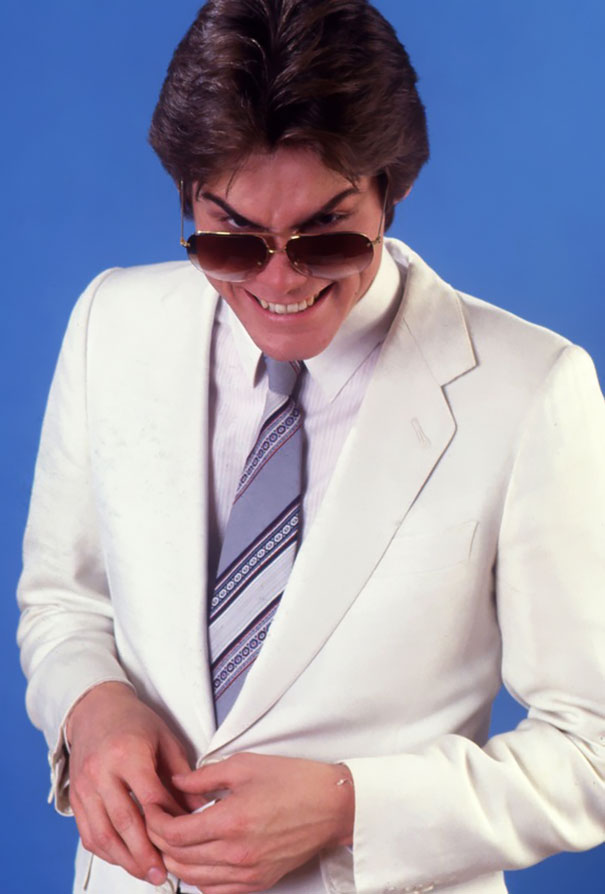 Young Jim Carrey in a white suit and sunglasses performing manic celeb impressions in 1992 before he was famous. Young Jim Carrey in a white suit and sunglasses performing manic celeb impressions in 1992 before he was famous.