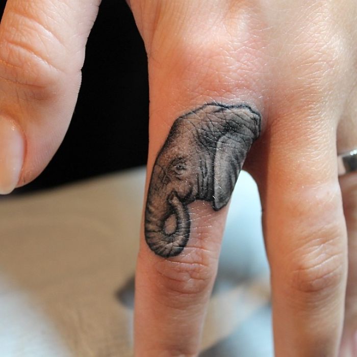 Elephant design finger tattoo showcasing the latest trend in body art.
