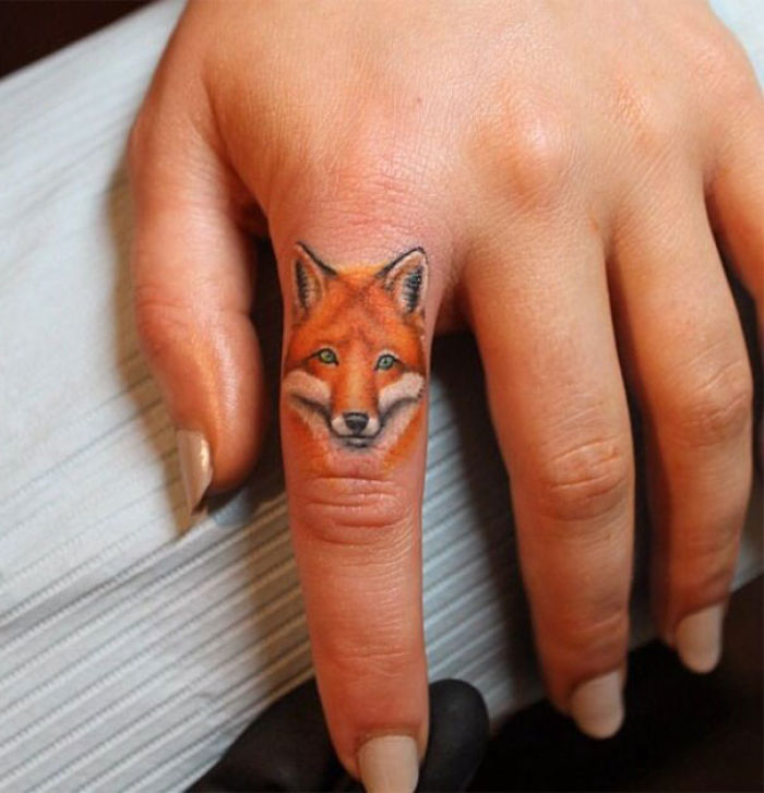 Fox tattoo on finger, showcasing the newest trend in finger tattoos.