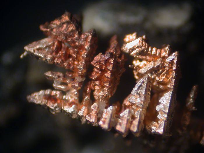 Close-up of a beautiful copper mineral formation with intricate crystalline structures.
