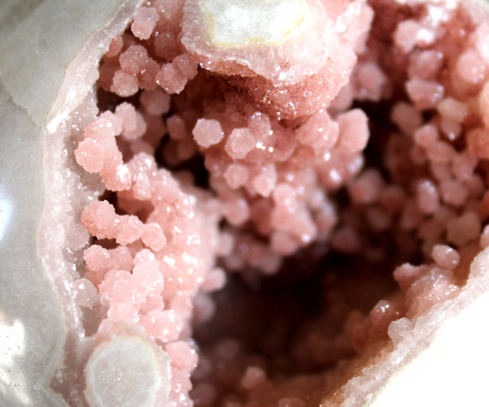 Close-up of beautiful pink mineral crystals inside a geode.