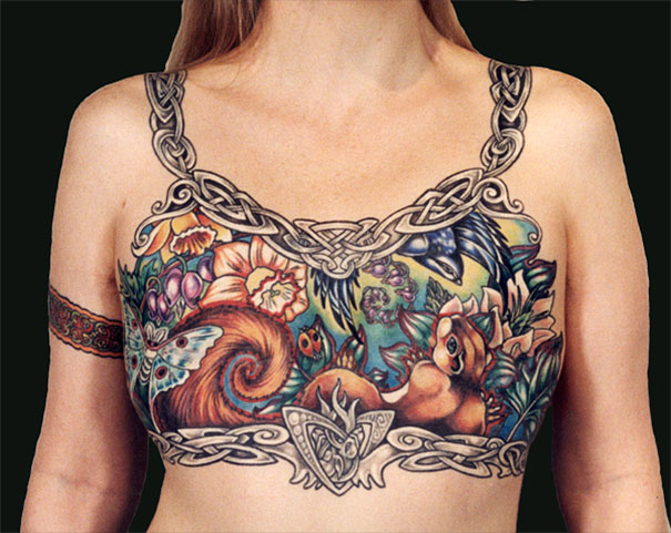 Breast cancer survivor's mastectomy scars covered with colorful nature-themed tattoo art. Breast cancer survivor's mastectomy scars covered with colorful nature-themed tattoo art.