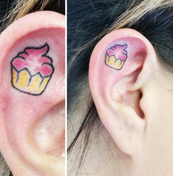 Creative ear tattoo featuring a colorful cupcake design.