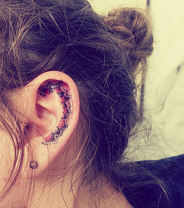 Artistic ear tattoo with colorful geometric design on the inner ear, showcasing creative ear tattoos.