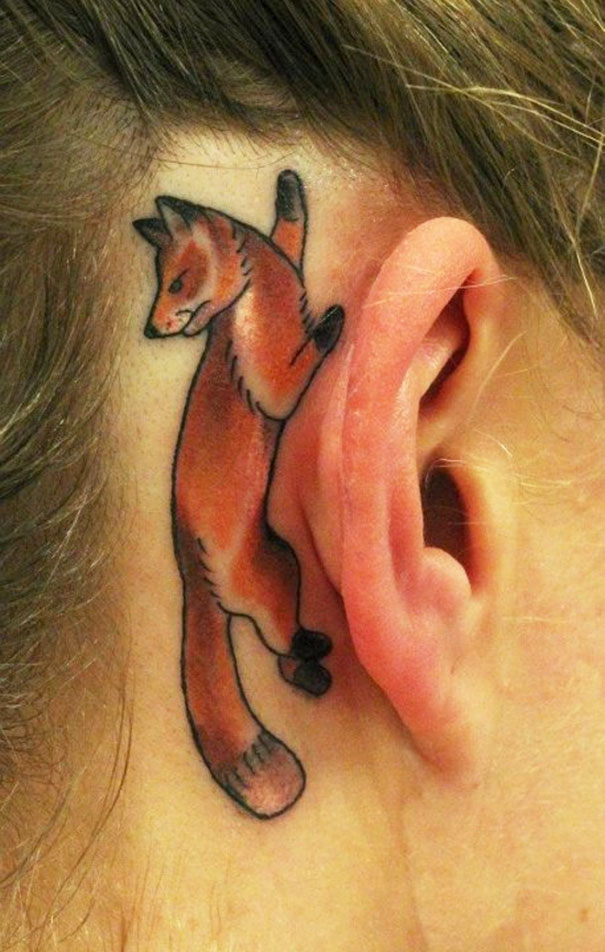 Creative ear tattoo of a fox design behind the ear.