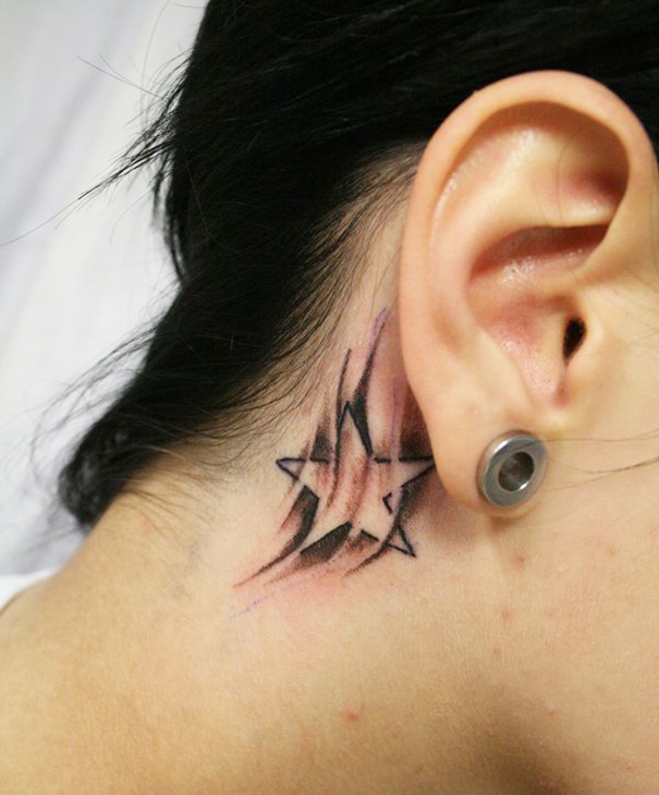 Creative ear tattoo of geometric star pattern behind the ear.