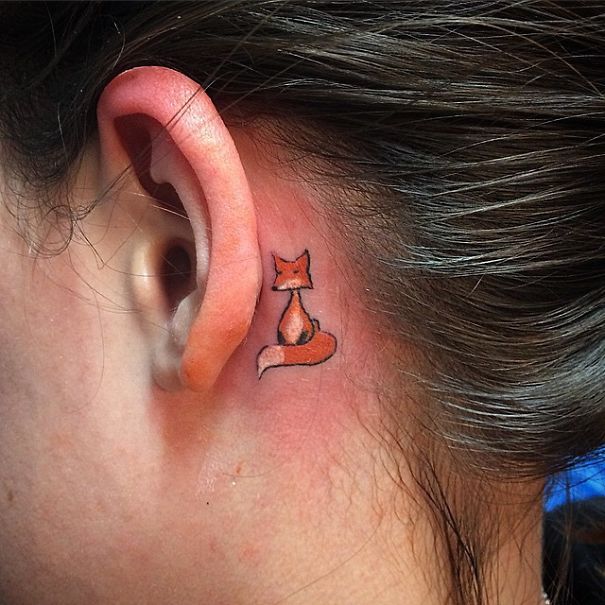 Creative ear tattoo of a minimalist fox design on the inner ear.