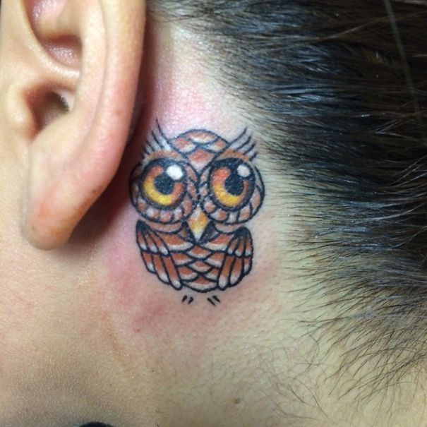 Creative ear tattoo of an owl behind the ear.
