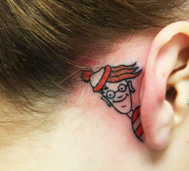 Creative ear tattoo featuring a colorful design behind the ear.