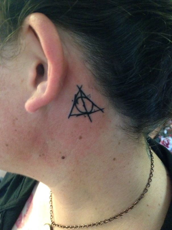 Creative ear tattoo featuring a geometric design behind the ear.