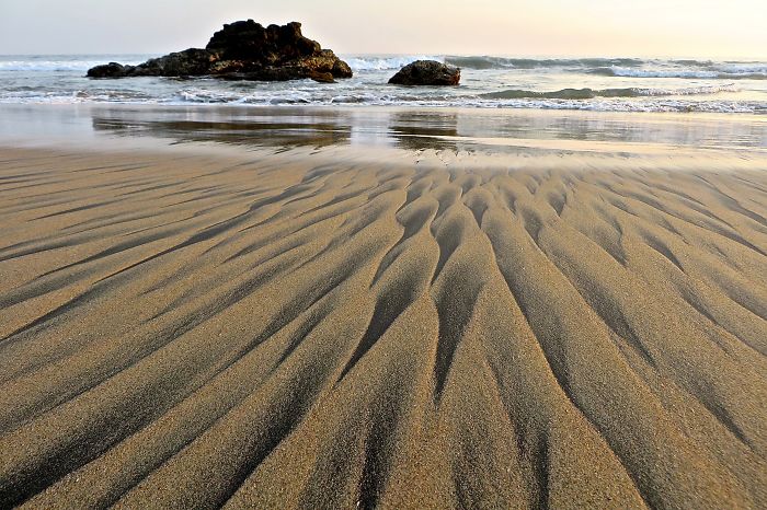 The Wave Left Behind Sand People On The Beach
