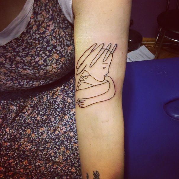 Picasso-inspired tattoo on forearm, featuring minimalist line art of an abstract face and figure.