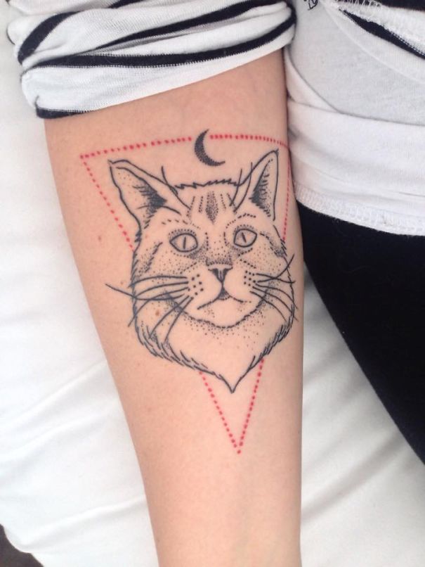 Line art tattoo of a cat's face with a crescent moon, designed for cat lovers.