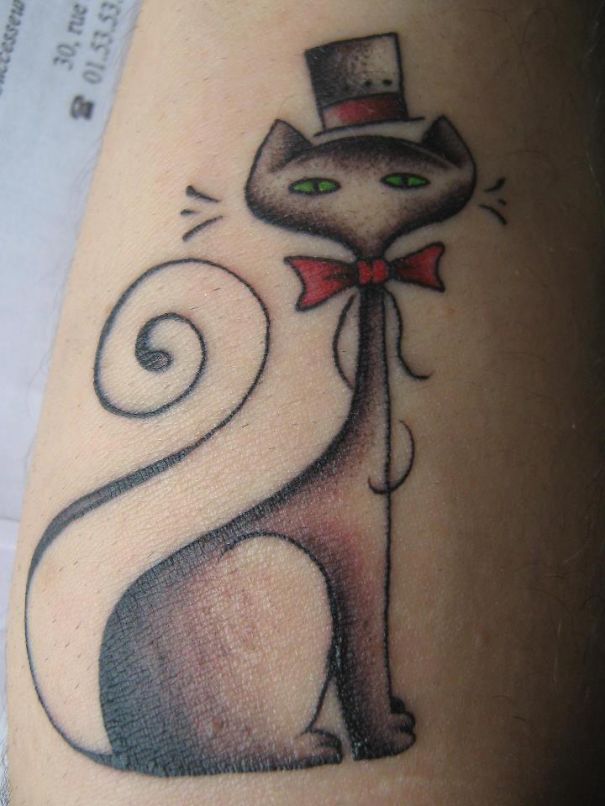 Line art cat tattoo with a top hat and bow tie, perfect for cat lovers seeking unique designs.