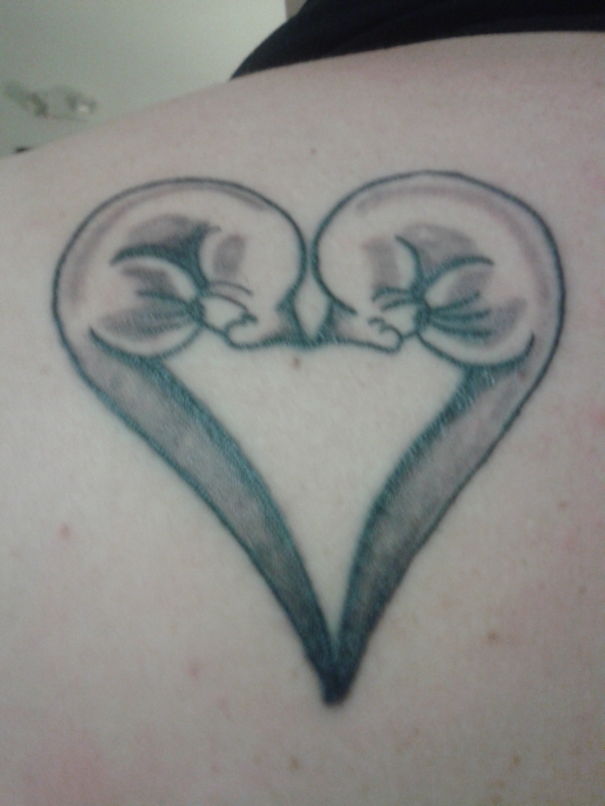 Simple cat tattoo design featuring two cats forming a heart shape, ideal for cat lovers.