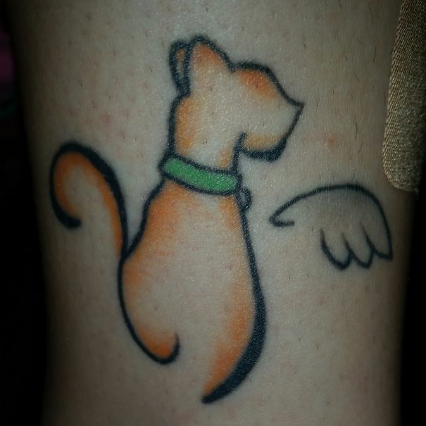 Simple cat tattoo design featuring a minimalist line art style with a green collar and wing detail.