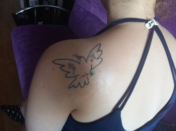 Picasso-inspired tattoo of a dove with colorful accents on shoulder, perfect for art lovers.