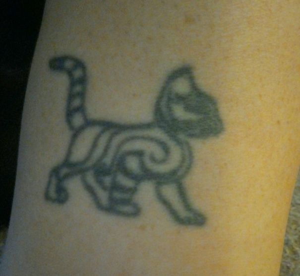 Simple cat tattoo in line art on skin, featuring abstract patterns for cat lovers.