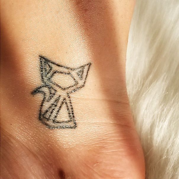 Line art of a simple cat tattoo on an ankle, featuring geometric shapes, ideal for cat lovers seeking minimalist designs.