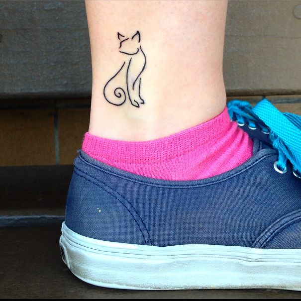 Simple cat line art tattoo on ankle, perfect for cat lovers.