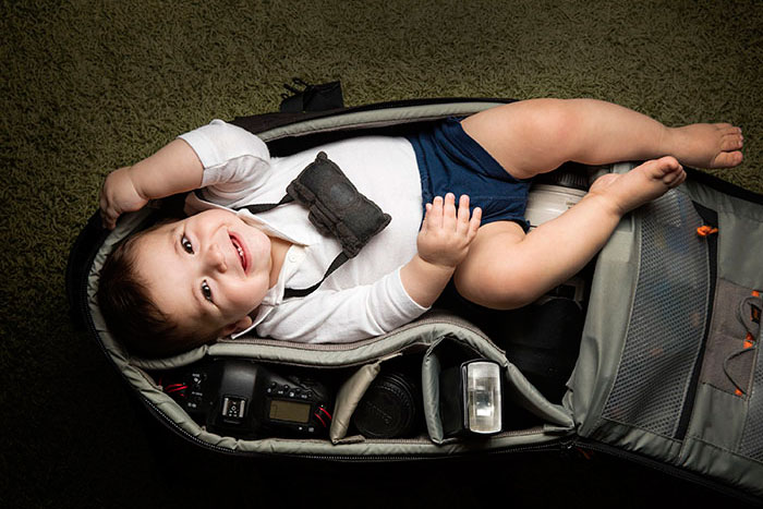 Child In Camera Bag