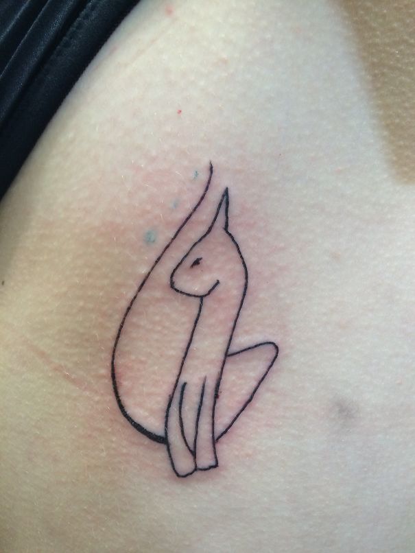 Simple line art cat tattoo design on skin, showcasing minimalistic style for cat enthusiasts.