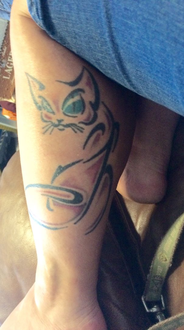 Simple cat tattoo design in line art style on a person's leg.