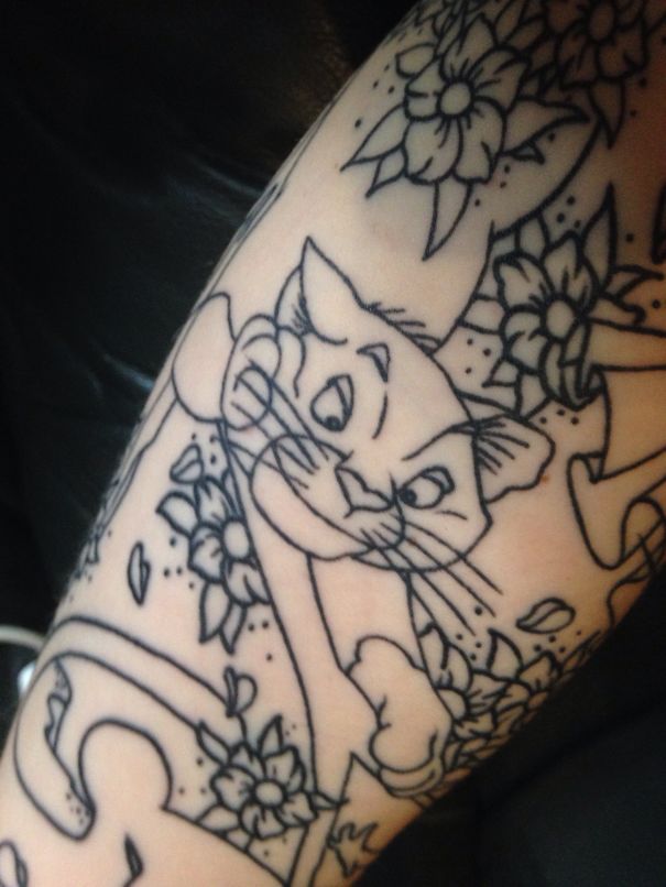 Line art of a playful cat integrated with floral elements, perfect for cat tattoo enthusiasts.