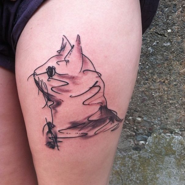 Picasso-inspired cat tattoo on a person's thigh, showcasing abstract and artistic lines.