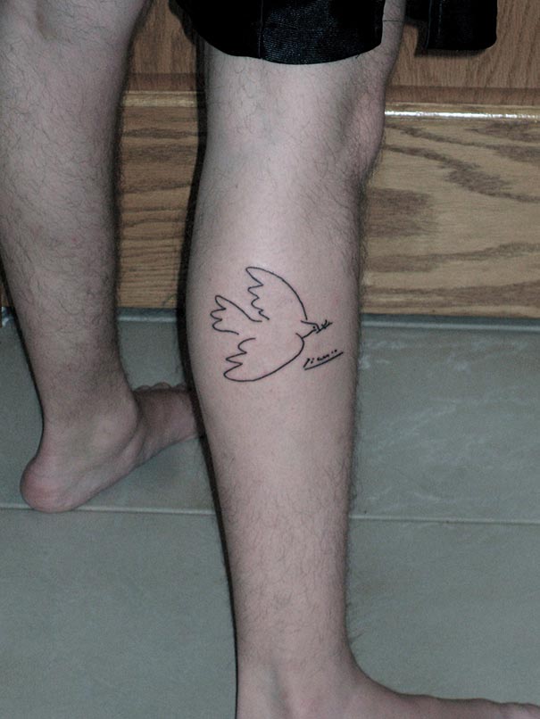 Minimalist tattoo of a Picasso-inspired dove on a person's leg.