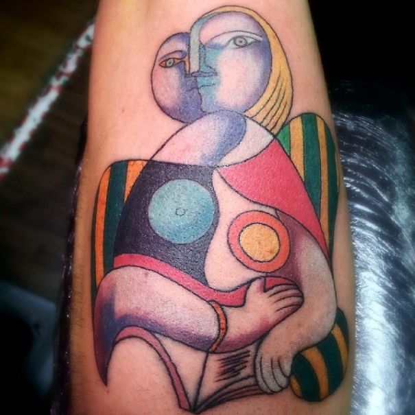 Tattoo inspired by Picasso's abstract art style, featuring vibrant geometric shapes and bold colors.