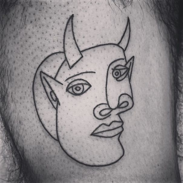 Picasso-inspired tattoo with abstract face and horns in minimalist line art style.