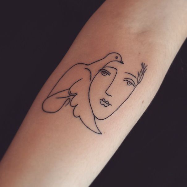Minimalist Picasso-inspired tattoo design with a face and bird.