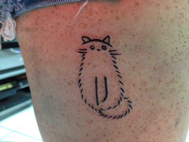 Simple cat tattoo line art on skin, showcasing a minimalist feline design.