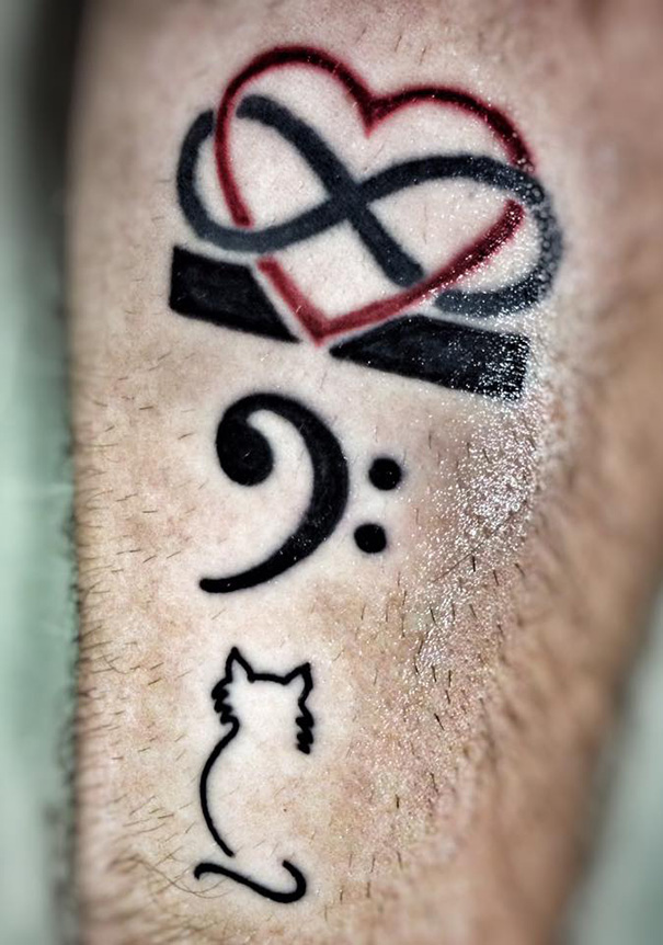 Line art cat tattoo with musical symbols and an infinity heart on skin.