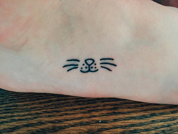 Simple cat tattoo design with whiskers and nose on a person's foot, ideal for cat lovers.