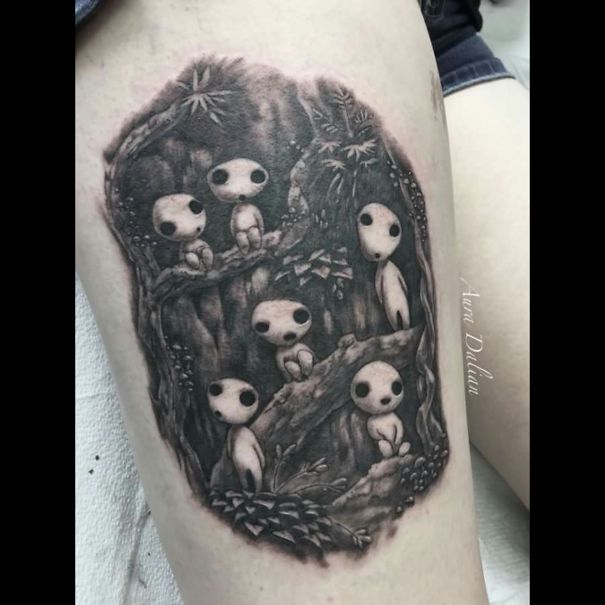 Studio Ghibli tattoo featuring forest spirits inspired by Miyazaki films, artistically detailed on skin.