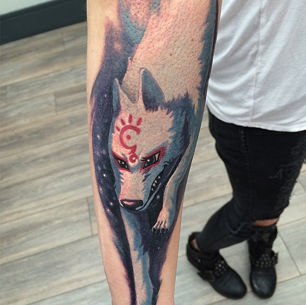 Studio Ghibli tattoo inspired by a Miyazaki film, featuring a detailed wolf on a person's forearm.