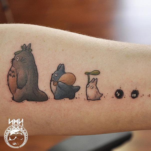 Studio Ghibli tattoo featuring Totoro and soot sprites on the forearm.