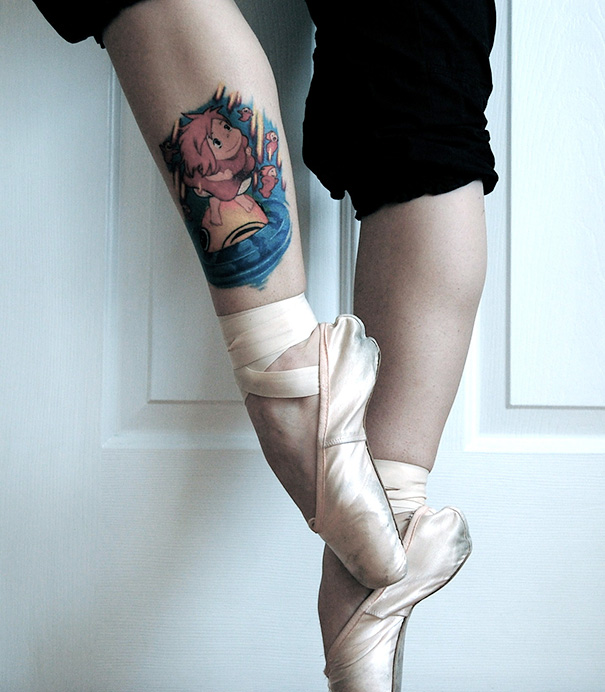 Ballet dancer with a colorful Studio Ghibli tattoo on calf, inspired by Miyazaki films.