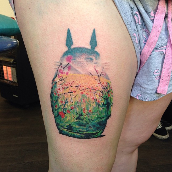 Studio Ghibli tattoo inspired by Miyazaki films, featuring a nature scene on a person's thigh.