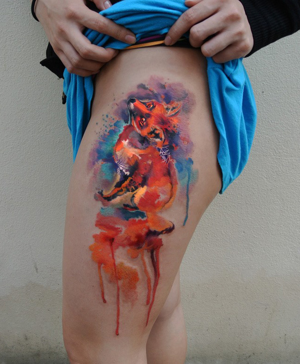 Colorful watercolor tattoo of a fox on a thigh, created by Czech artist Ondrej Konupcik. Colorful watercolor tattoo of a fox on a thigh, created by Czech artist Ondrej Konupcik.