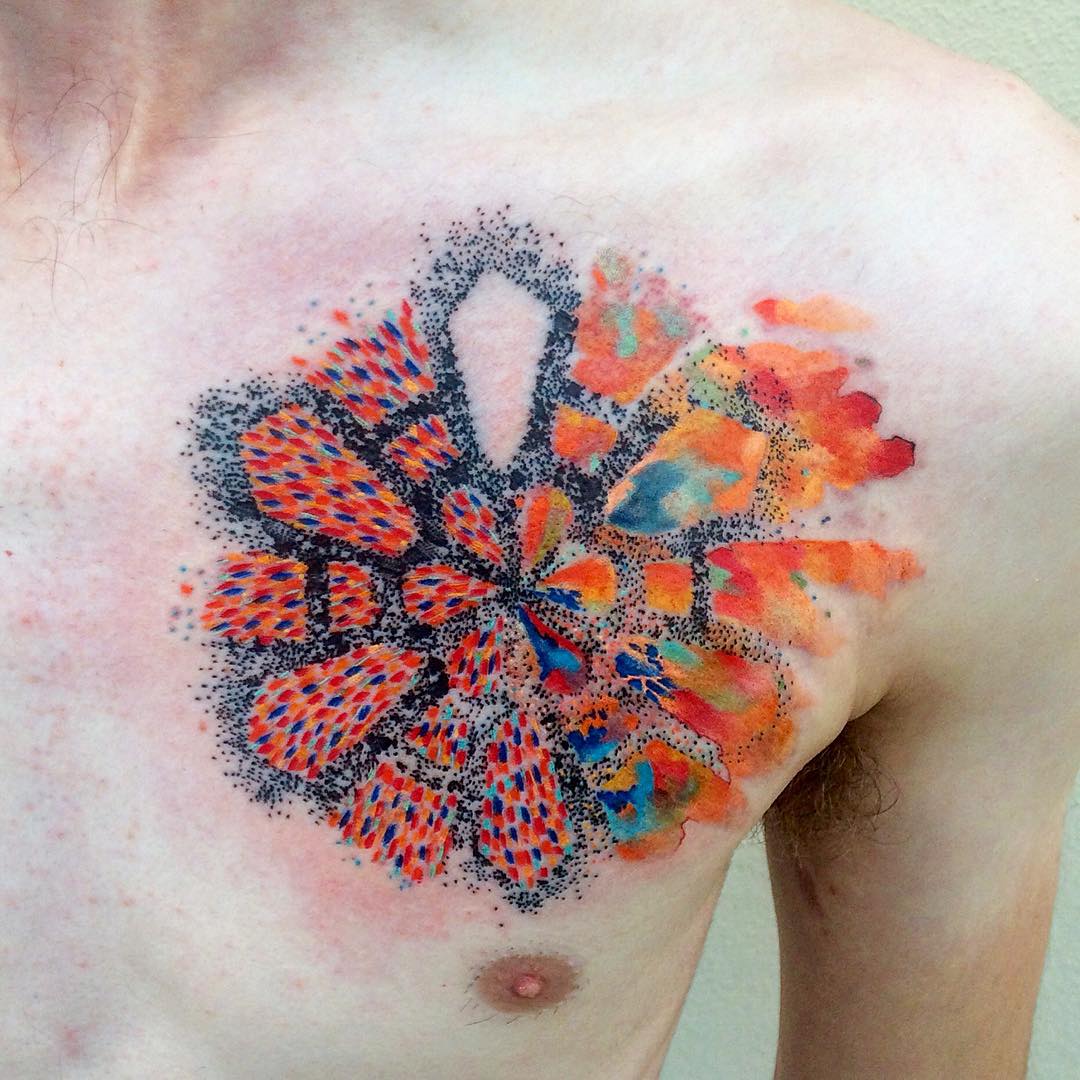 Colorful watercolor tattoo by Czech artist Ondrash, showcasing intricate patterns and vibrant colors on a person's chest. Colorful watercolor tattoo by Czech artist Ondrash, showcasing intricate patterns and vibrant colors on a person's chest.