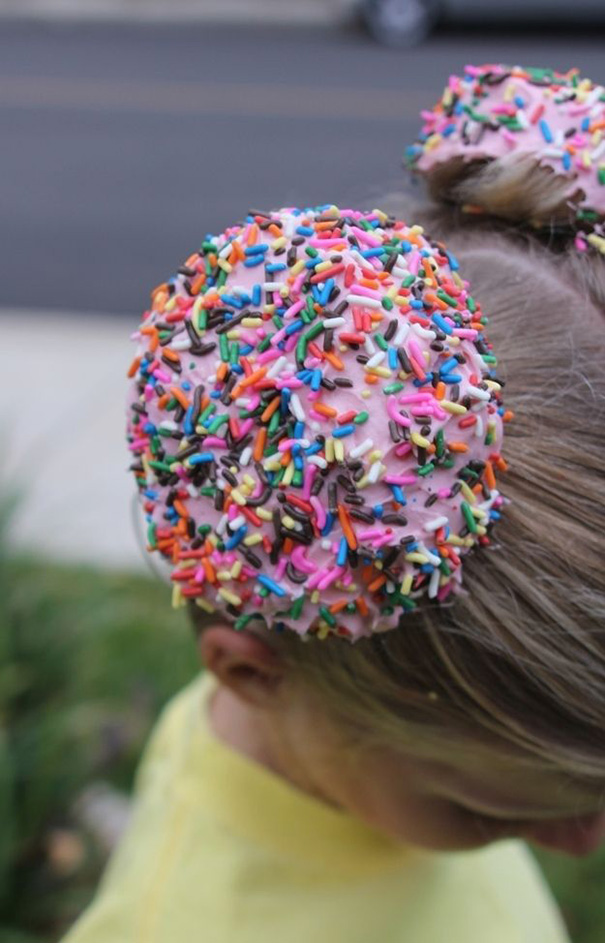Child with donut-inspired hairstyle featuring colorful sprinkles, perfect for crazy hair day.