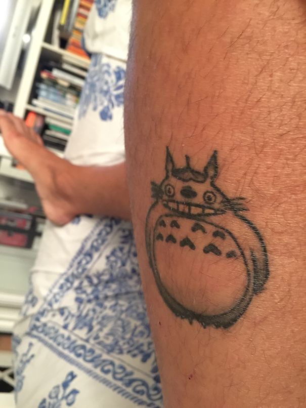 Studio Ghibli tattoo featuring Totoro from Miyazaki films on a person's leg.