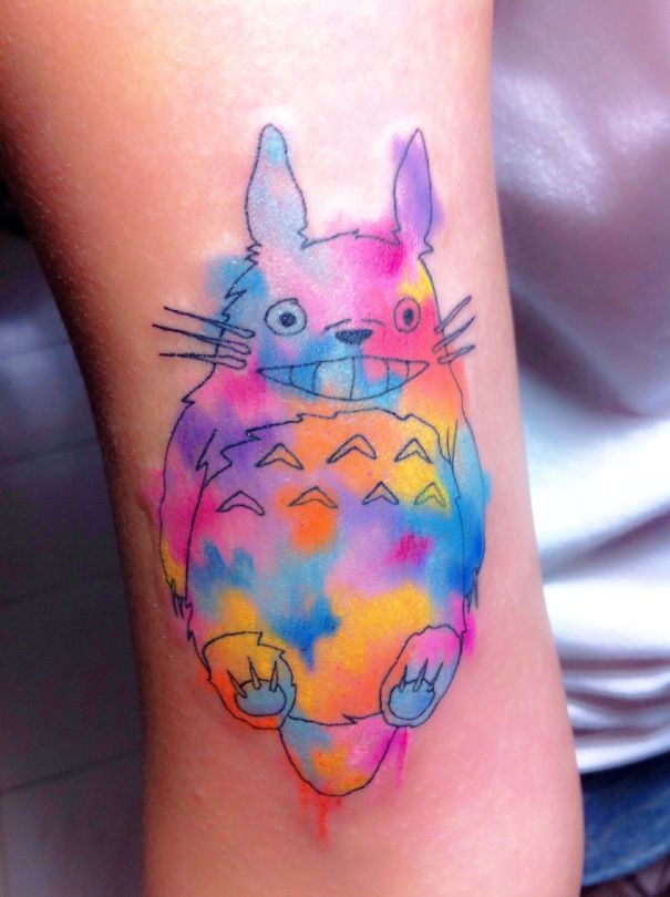 Colorful Studio Ghibli tattoo of a character inspired by Miyazaki films, featuring vibrant watercolor effects.