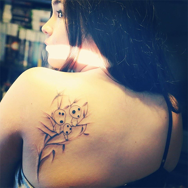 Woman with Studio Ghibli tattoo inspired by Miyazaki films on her shoulder.