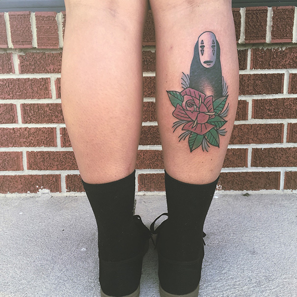 Studio Ghibli tattoo on a leg, featuring a character with a rose, inspired by Miyazaki films.